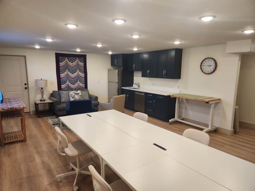 Sewing studio for six has two cutting tables, two ironing stations, and comfortable sewing chairs.