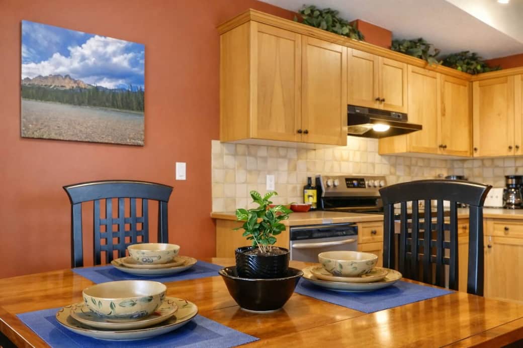 The dining table comfortably seats 4, with additional seating at the kitchen island. 