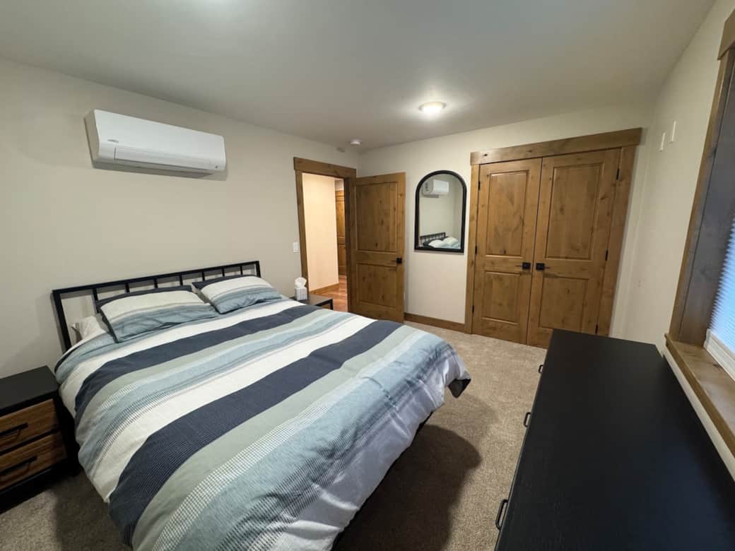 Bedroom has queen bed, dedicated ac/heat pump unit and TV mounted on wall