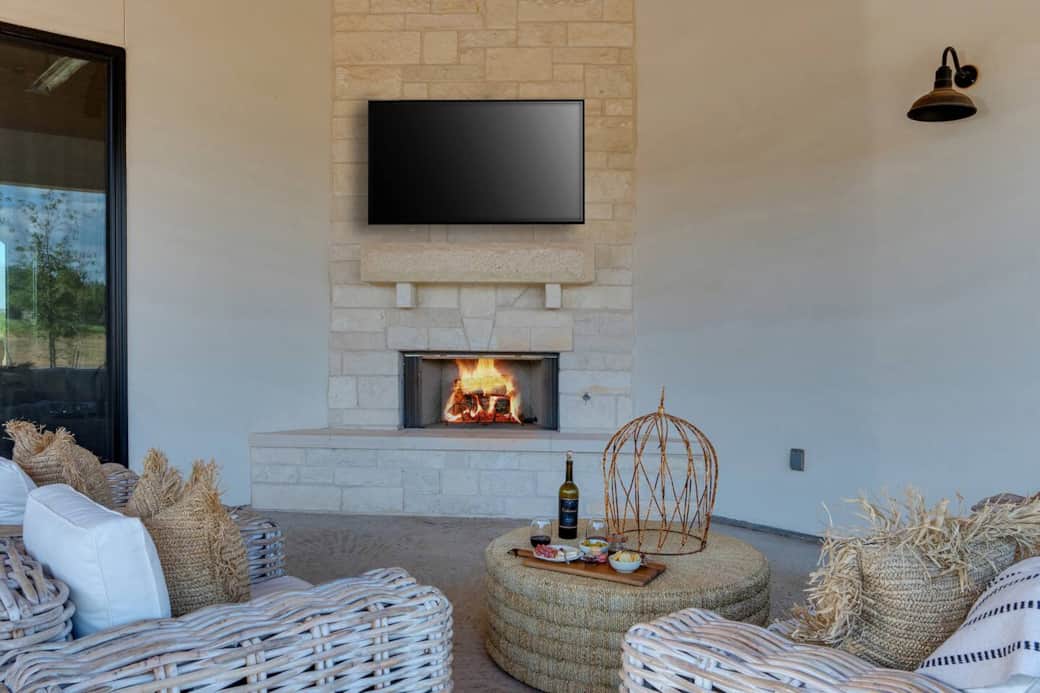 Outdoor fireplace and comfortable seating on the back patio perfect for evening gatherings.