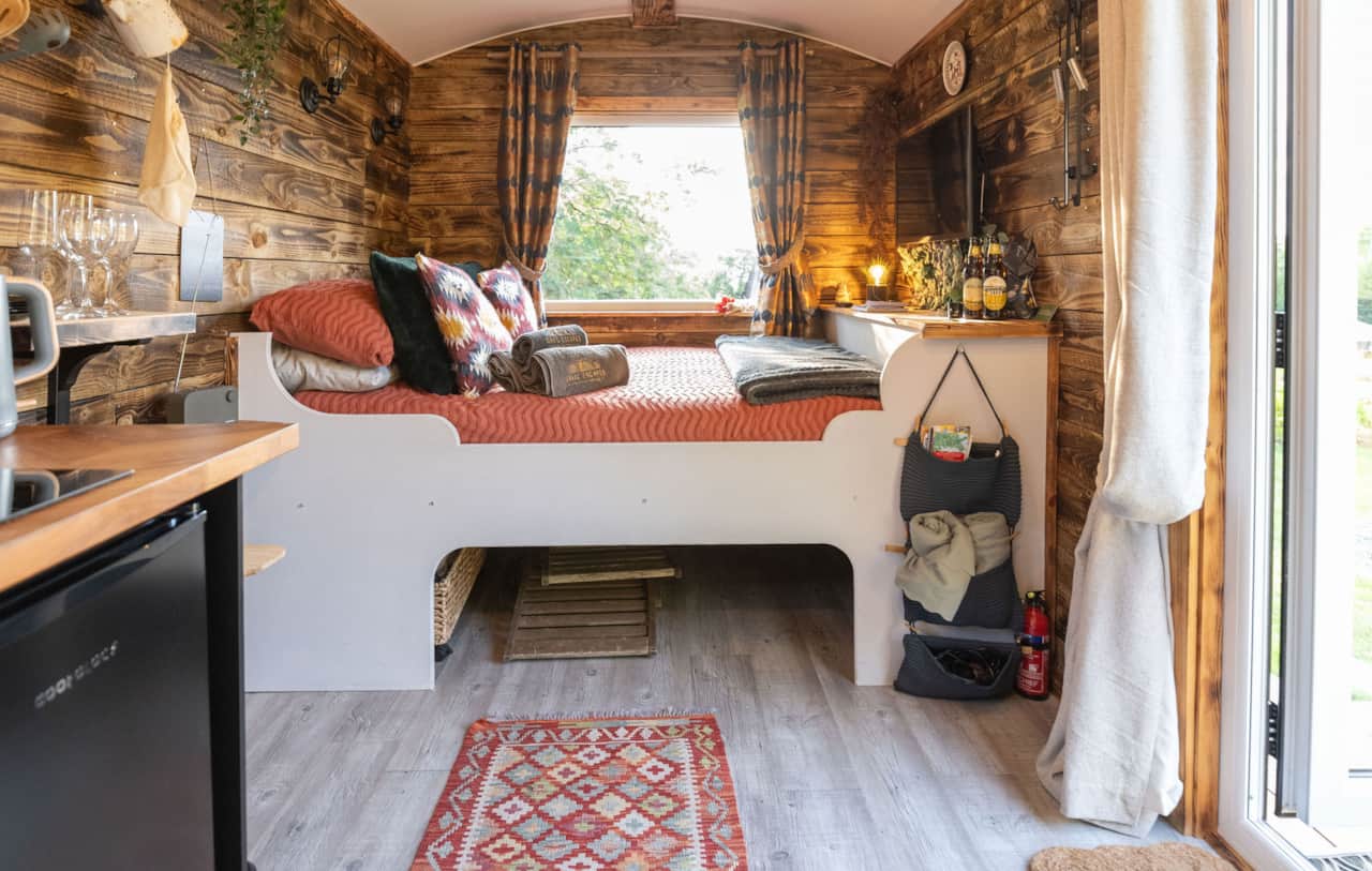 Cosy interior with bed, storage, and rustic decor