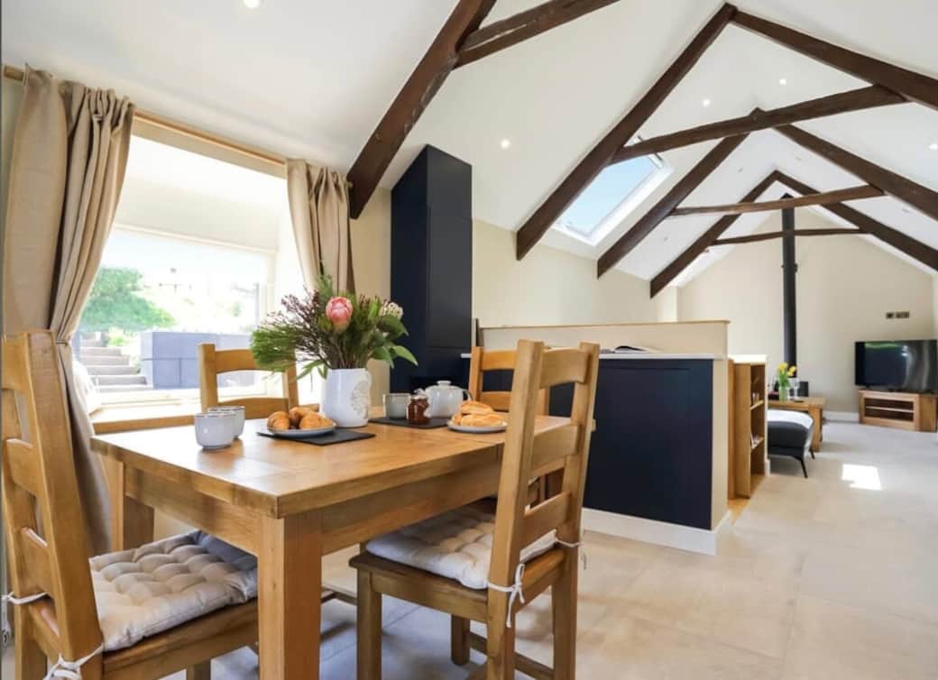 Four person dining table, that can extend to six for additional comfort, with blue tooth speaker and lamp to create the perfect evening in.