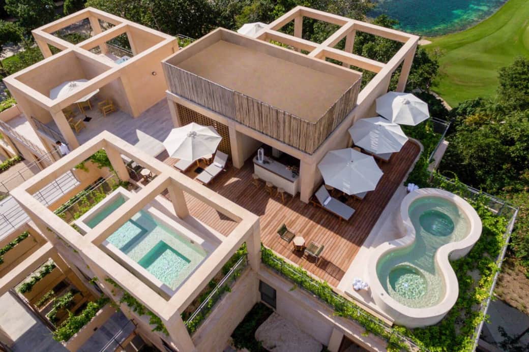 Rooftop common area featuring two hot tubs, a pool, bathrooms, and a dry bar, all set with amazing views, including overlooking the beautiful Gran Coyote Golf Course for a perfect place to relax and unwind.