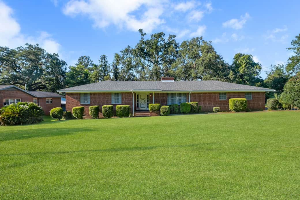 Large manicured lawn. Exterior Front
