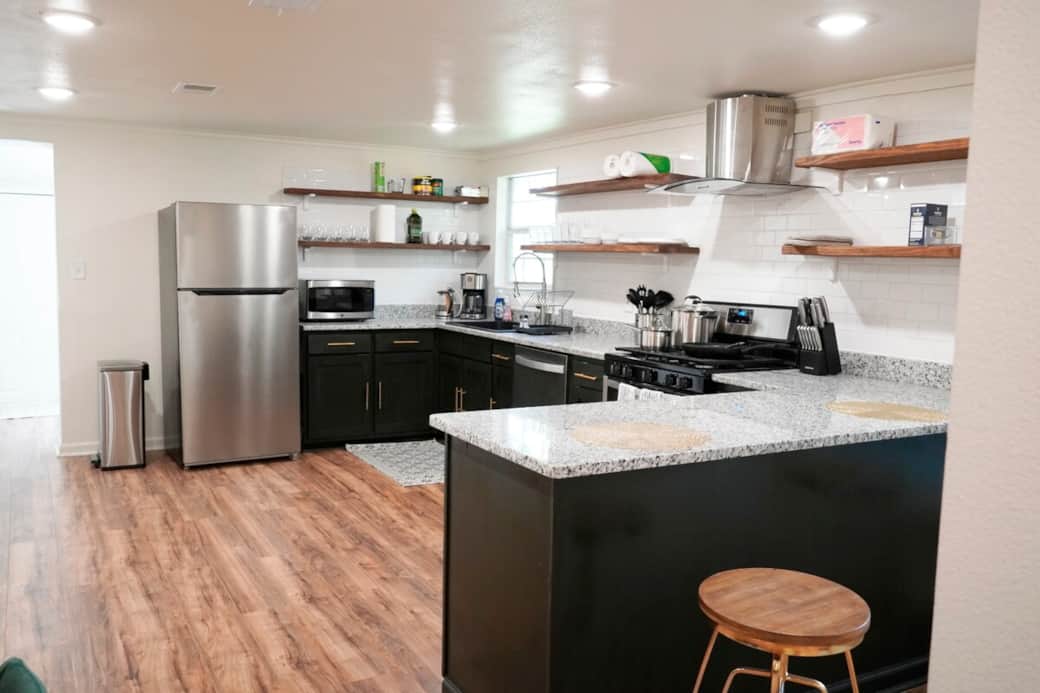 Open floorplan kitchen is family ready and fully stocked with dishes, pans, appliances and more. There is a bar top with additional seating for larger parties. 