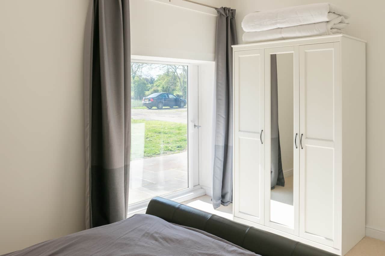 The bedroom looks over countryside and a private lake