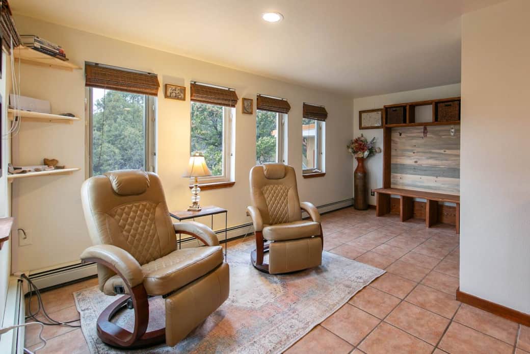 Seating area by kitchen. Cozy lounge by kitchen windows with sunrise and mountain views.