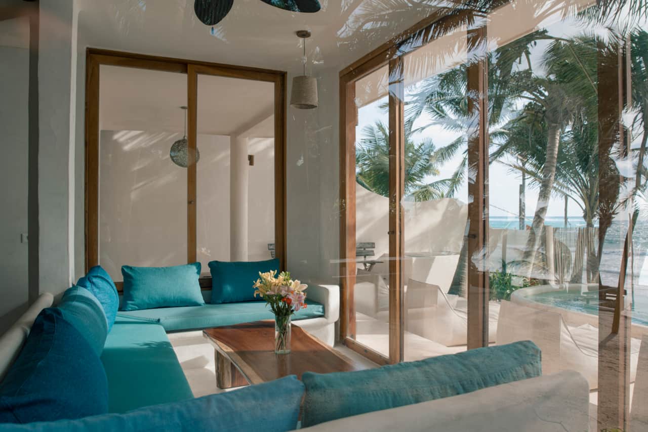 Turquoise sea views from living area with glass windows