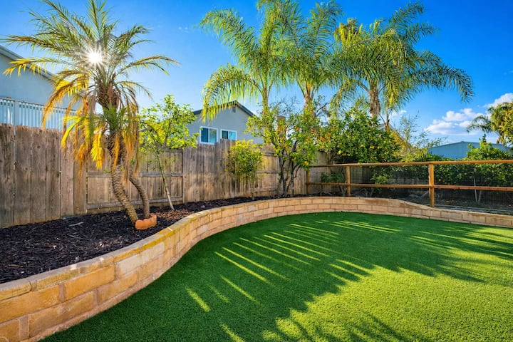Spacious private backyard with palm trees and plenty of room to relax.