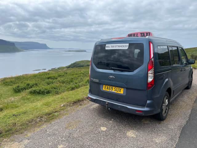 Mull Taxi vehicle beside a coastal viewpoint on the Isle of Mull