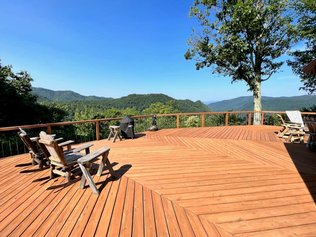 Large deck across back of house with beautiful views Large deck across back of house with beautiful views