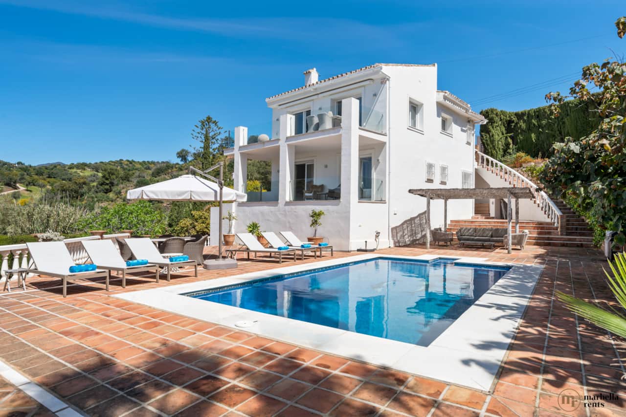 Swimming pool with sun loungers.