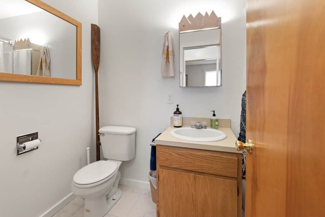 Clean 1st floor en-suite full bathroom with ceiling fan. Curved shower bar for space, large shower head with detachable wand.