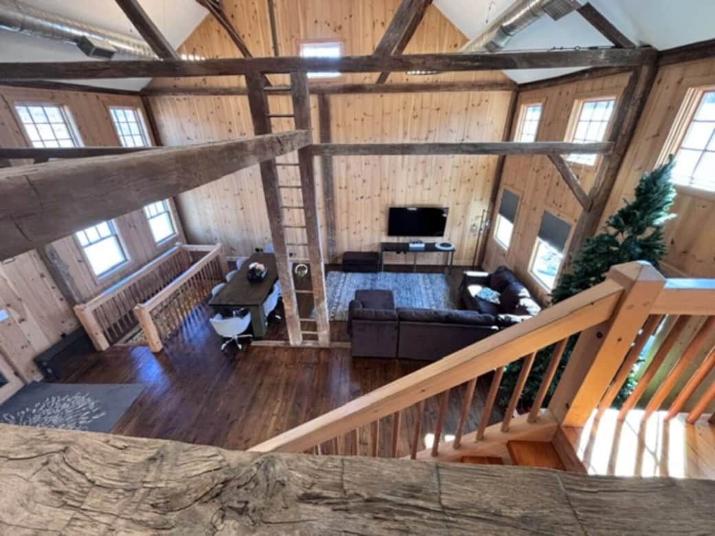This inviting living room offers a plush L-shaped sofa designed for comfort, along with a large screen TV for streaming your favorite shows. The space is cozy, open, and perfect for gathering, lounging, or enjoying a quiet night in.