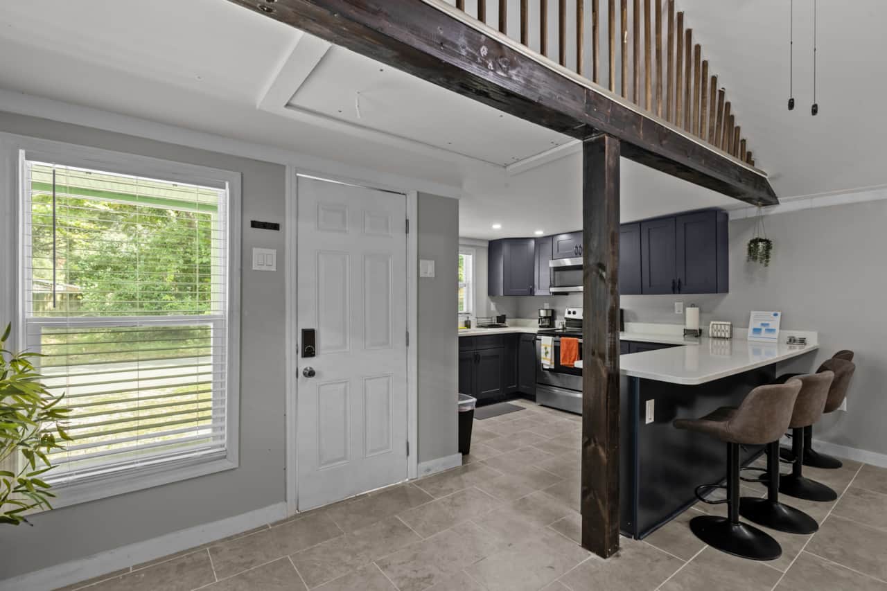 Property entrance with smart lock. Kitchen view and dinning area for 4 people.