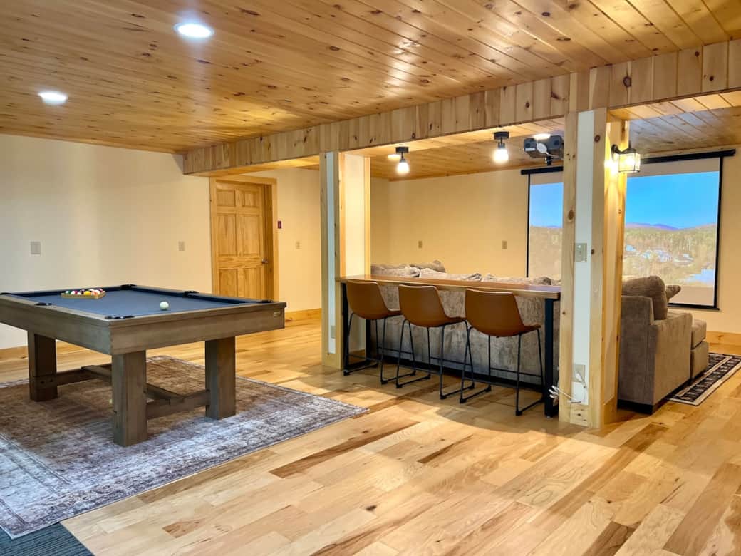 Step into the lower level rec room featuring a home movie theater - perfect for cozy movie nights or game-day excitement. Challenge friends and family to a game, or simply unwind. From here, you can step outside and enjoy a relaxing soak in the spa