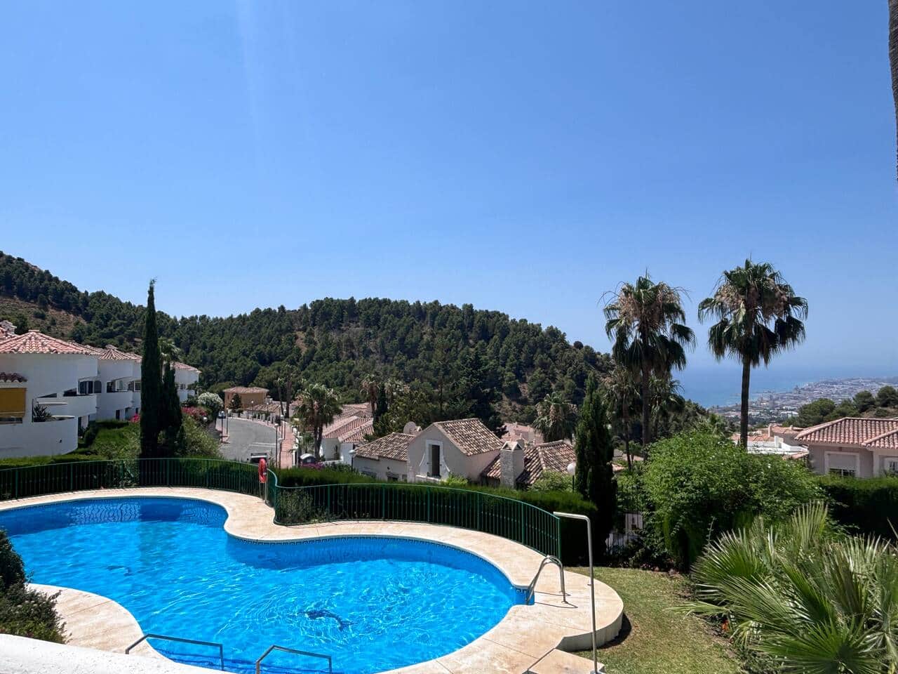 Community pool surrounded by peaceful Mediterranean scenery.