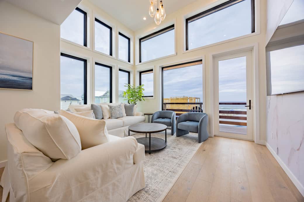 Bright living room with white sofas and ocean views at Driftwood Carolina beach house Bright living room with white sofas and ocean views at Driftwood Carolina beach house