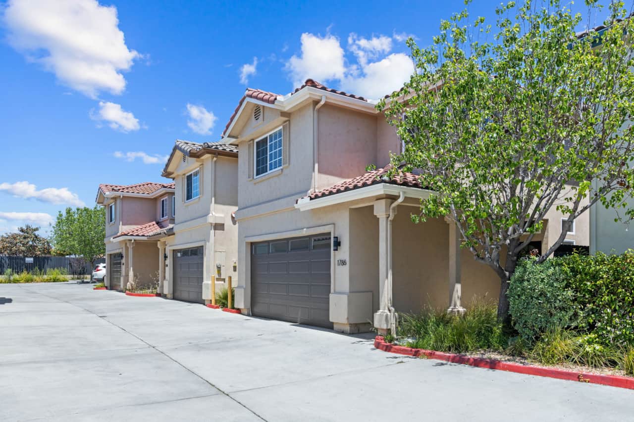 Modern 2-story home with tile roof, private entry, and attached garage.