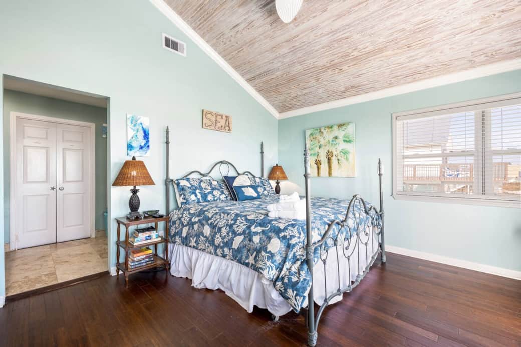 Master bedroom features king-size bed.
