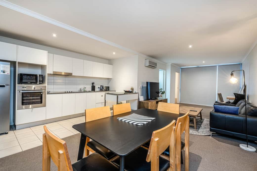 Experience the perfect blend of dining in our open-concept space. The dining table, surrounded by comfortable chairs, is ideal for family meals or hosting friends. The kitchen, with its modern appliances, making this area the heart of the home