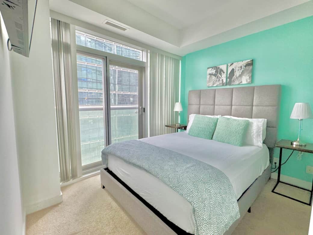 Rest and recharge in a serene bedroom featuring a plush queen-size bed, soft linens, ample storage, a Smart TV, and a private full-size bathroom. Enjoy the perfect blend of comfort, entertainment, and privacy in your own peaceful retreat.