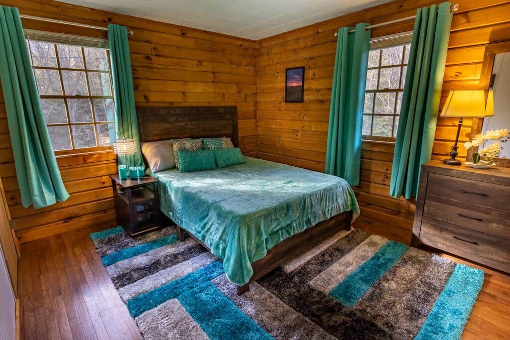 The master bedroom in the back corner of the cabin has remarkable views, and has its own TV The master bedroom in the back corner of the cabin has remarkable views, and has its own TV