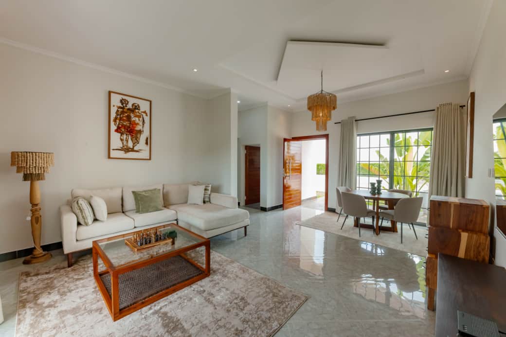 Bright living room with smart TV and dining table