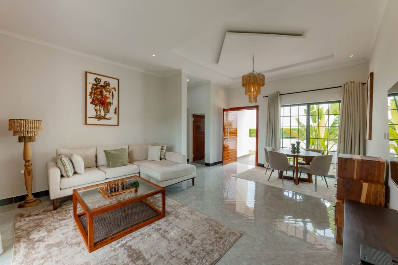 Bright living room with smart TV and dining table