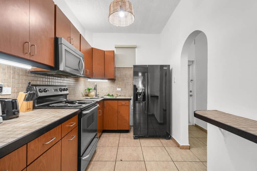 Full kitchen with fridge, stove, microwave, and essentials