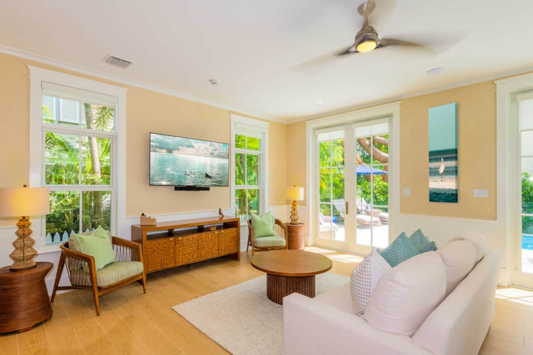 Bright family room with open-concept design, pool access, and relaxed coastal style. Bright family room with open-concept design, pool access, and relaxed coastal style.