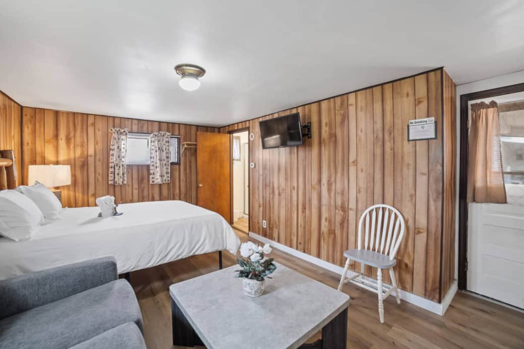Spacious room with rustic charm, complete with a smart TV and a chic coffee table for relaxing evenings.