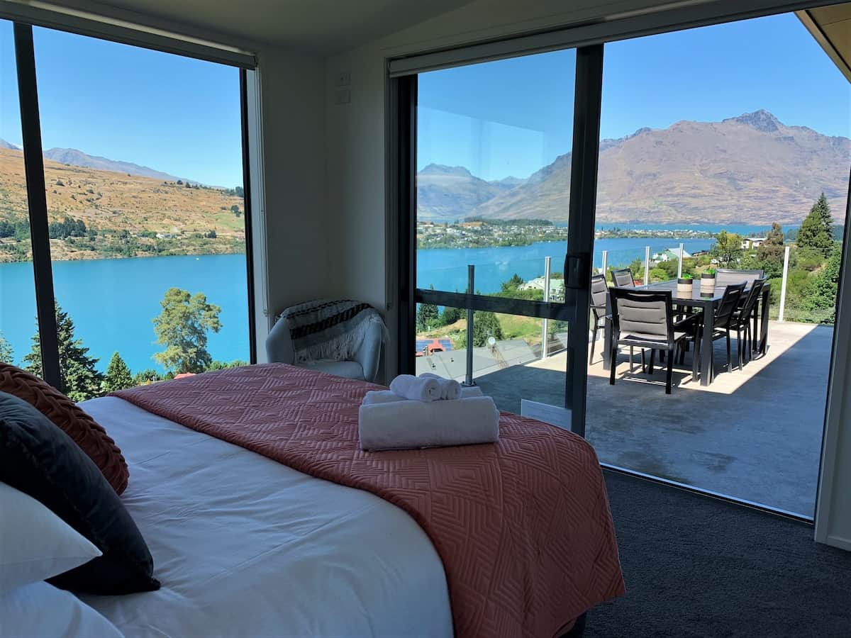 Bedroom 1 with breathtaking lake views and access to balcony