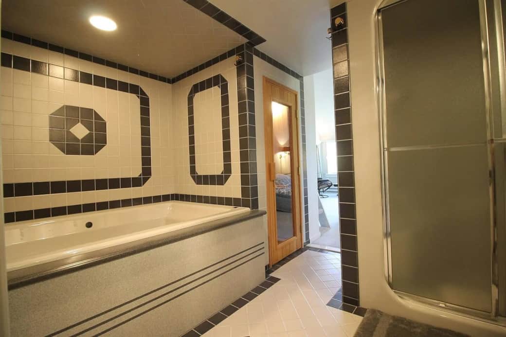 This master bathroom has two sinks, a jacuzzi tub, a steam shower, and a sauna.
