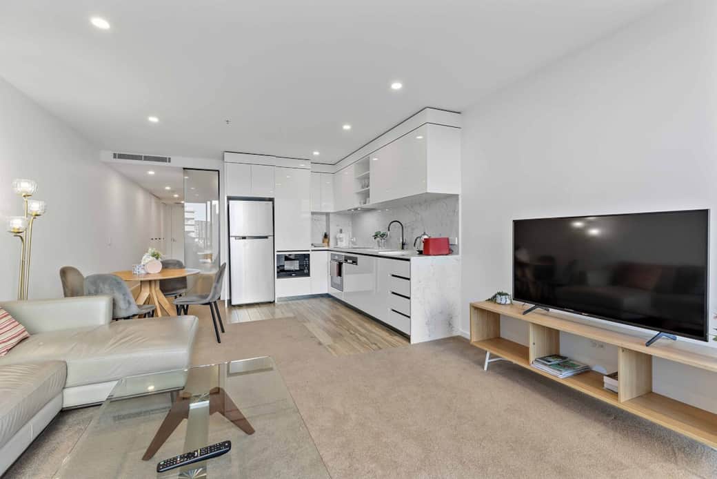 Step into a contemporary living space that seamlessly blends comfort and style. The open layout is perfect for socializing, with a dining area that flows into a well-equipped kitchen