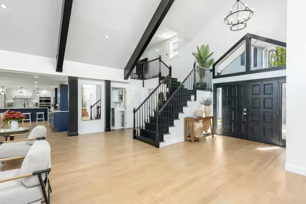 The entryway exudes luxury with clean lines, vaulted high ceilings, and sleek finishes. 