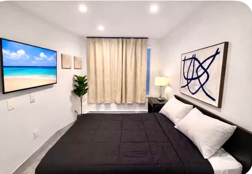 Welcome to this beautiful room! It features a cozy queen bed, small closet, and a flat-screen TV for your entertainment. The decor is both stunning and thoughtfully curated, making it a lovely space to relax and unwind. Enjoy your stay!!
