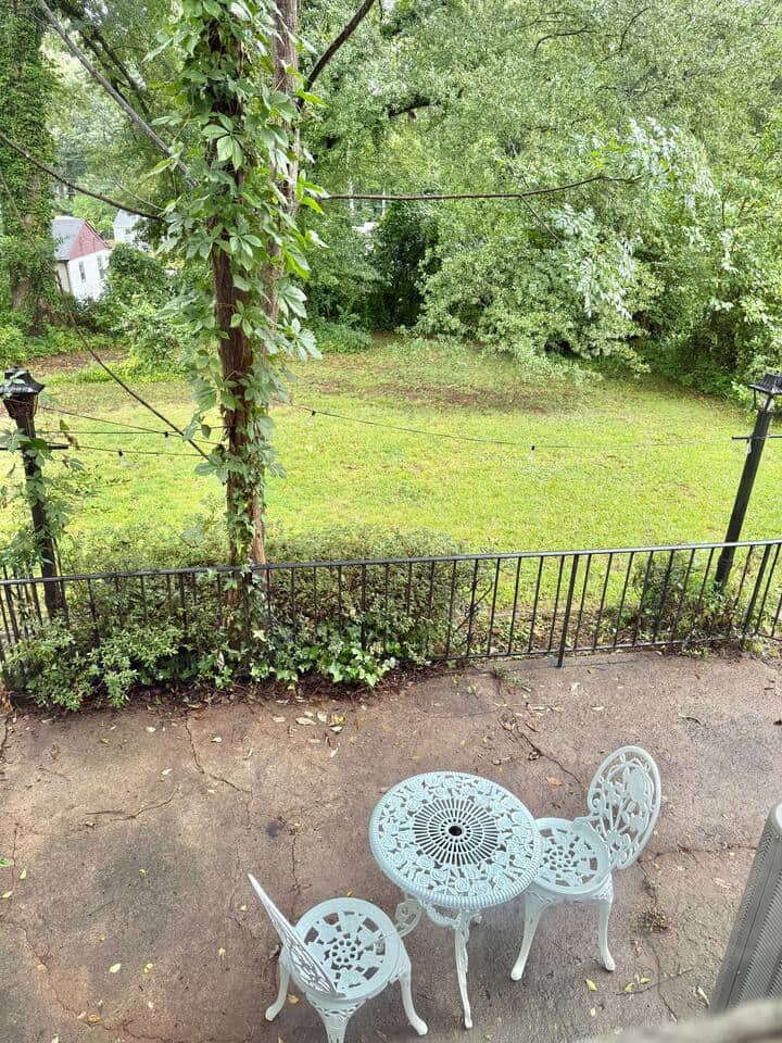 This is the backyard view from the queen bedroom, featuring a nice victorian seating area on the large patio.