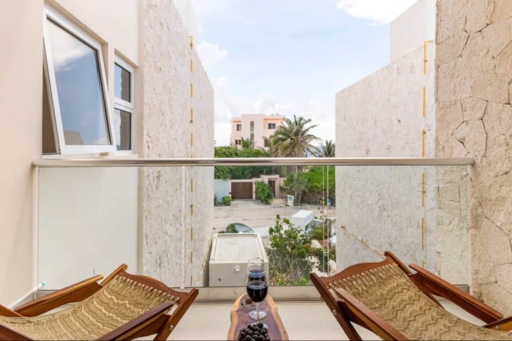 This private balcony offers a relaxing outdoor space with ocean views and comfortable outdoor furniture, perfect for enjoying a morning coffee or unwinding with a drink while taking in the sea breeze and coastal scenery.