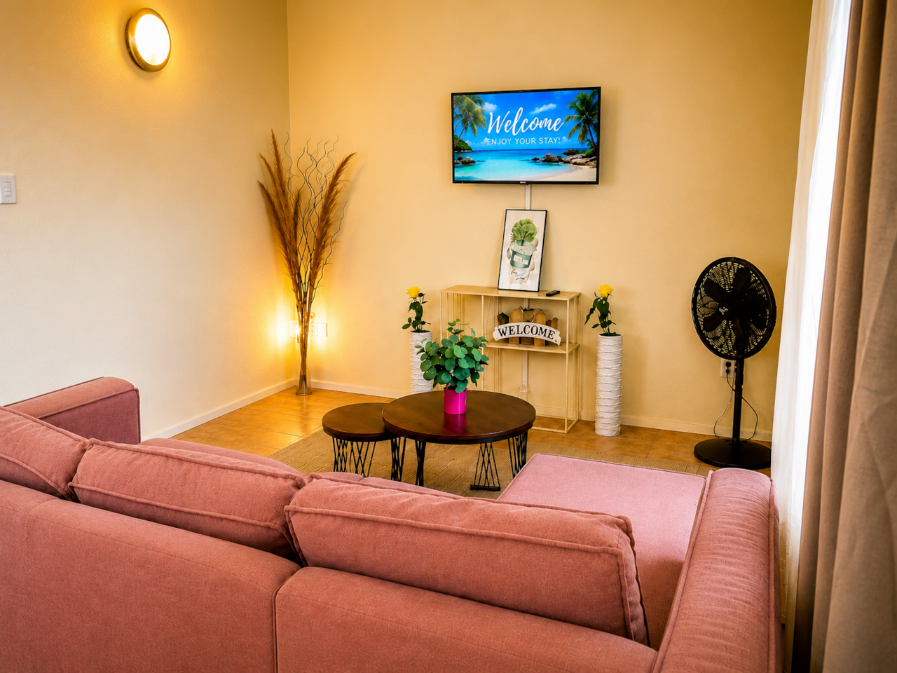 Spacious living room with sectional sofa and TV, perfect for relaxing together.
