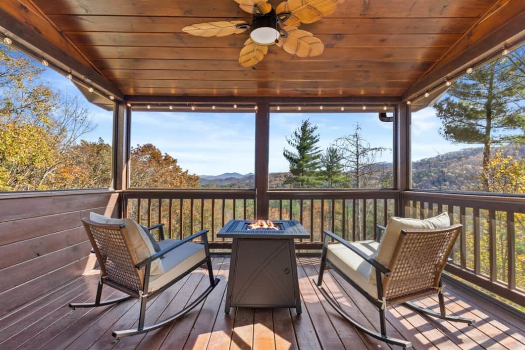 Private upper deck with two rocking chairs, a cozy fire table, and stunning views—accessible directly from the bedroom for peaceful, relaxing mornings.
