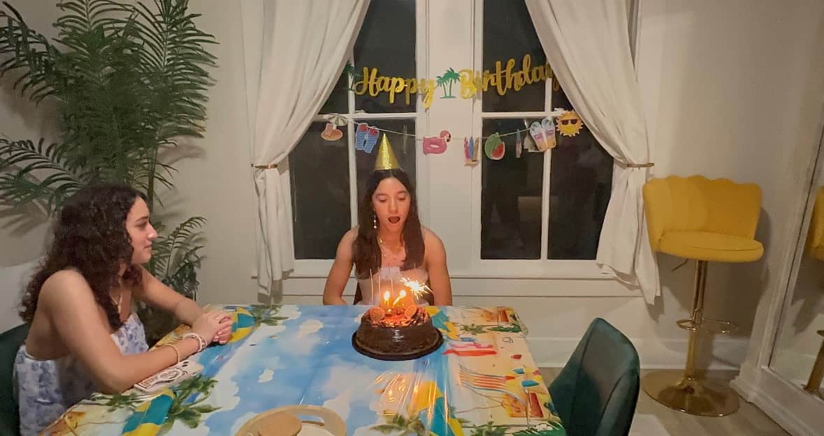 Teen birthday celebration at White Magnolia Galveston with a cake and candles