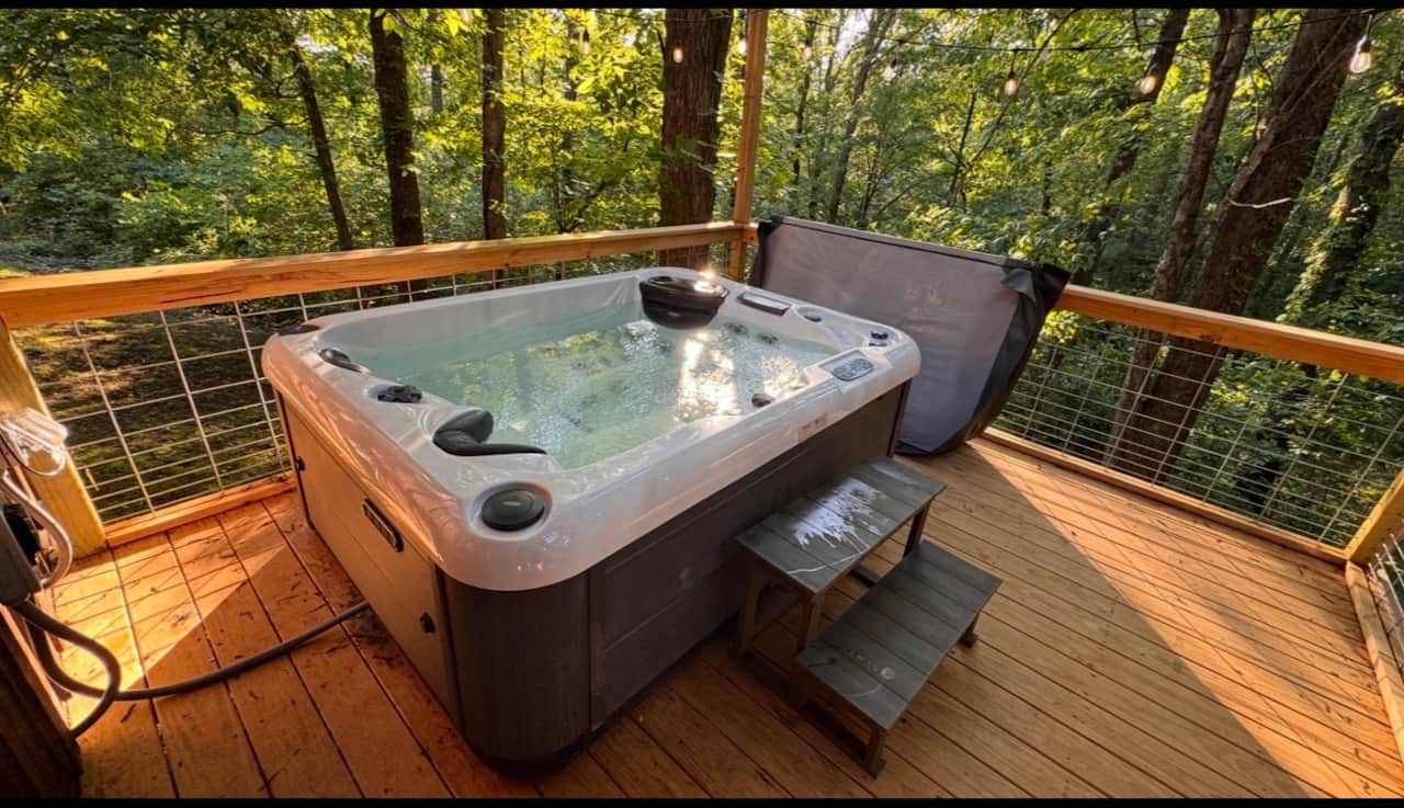 Private hot tub on a forest cabin deck near Cave Run Lake