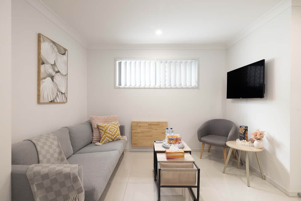 Living Area: Bright living space with comfortable seating and TV 