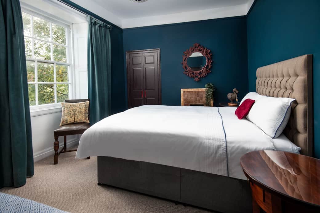 Rich blue room for a Dodo-inspired Caucus Race! Luxurious bed and mascot guarantee a fun, restful st