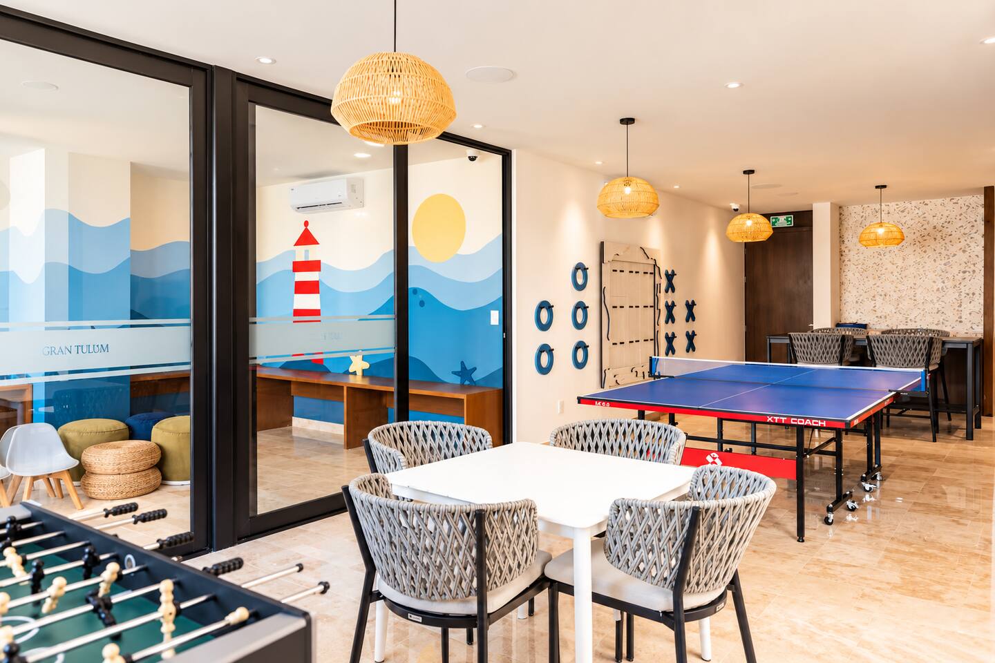 El salón de juegos, junto al centro de actividades infantiles, cuenta con ping pong, futbolito, gato y damas gigantes montados en la pared, además de mesas y asientos para que todos disfruten.