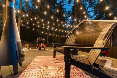 Modern wood stove and Adirondack chairs. (Please note there may be fire bans in the summer)