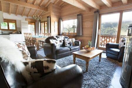 Lounge area with 3 sofas and woodburning stove