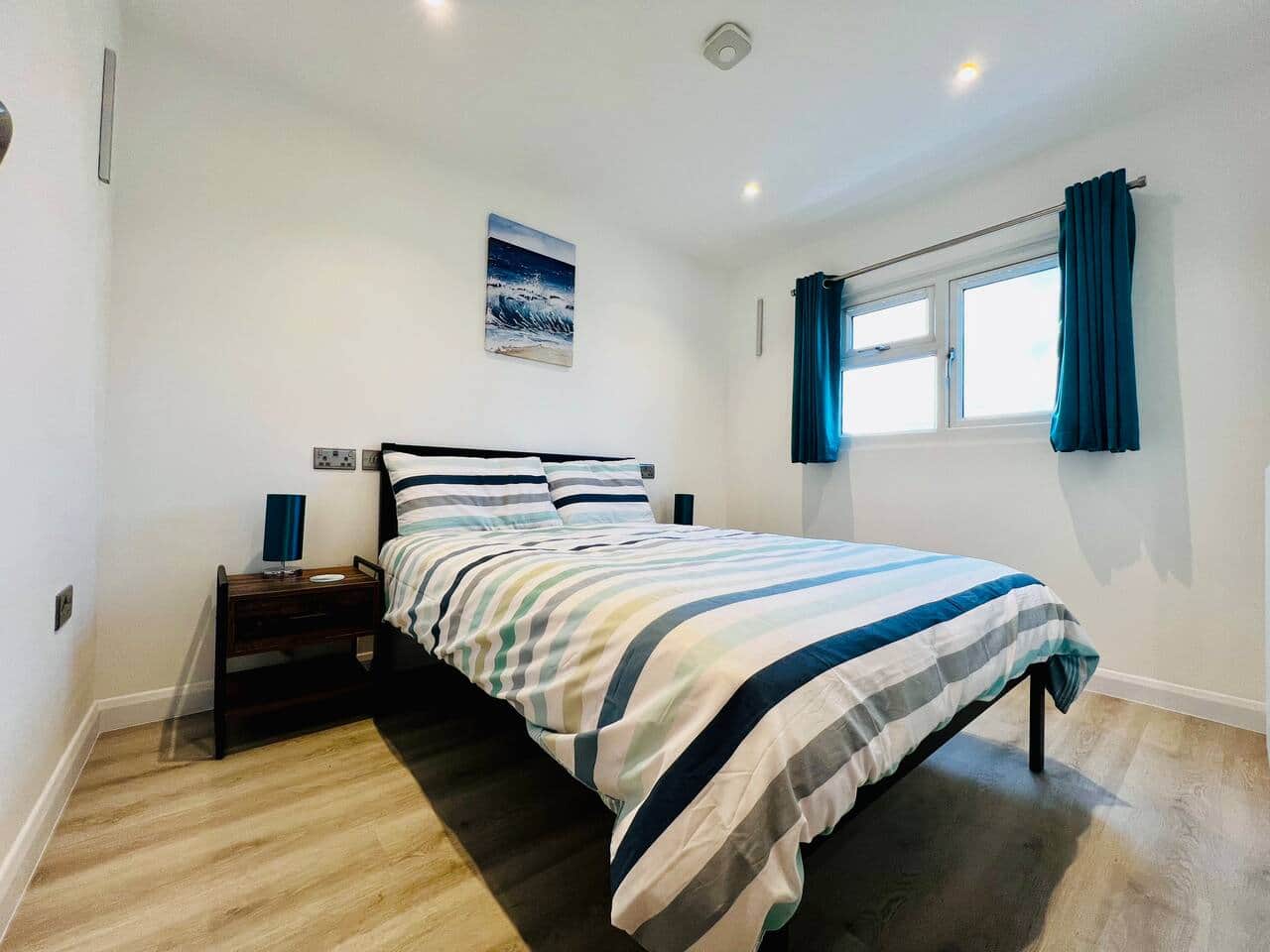 Comfortable double bedroom with fresh linen and storage space