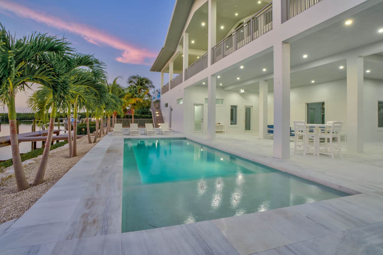 Sunset view of the pool and palm trees